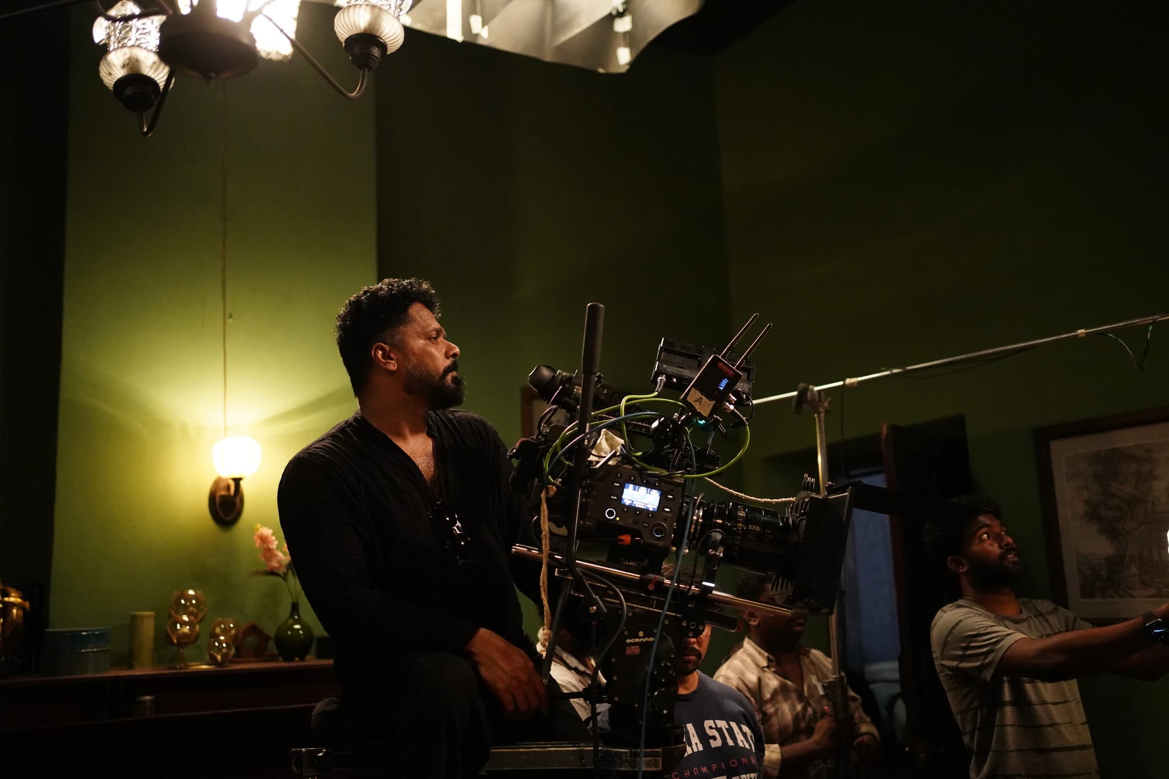 Aashiq Abu operating the camera on the set of Rifle Club